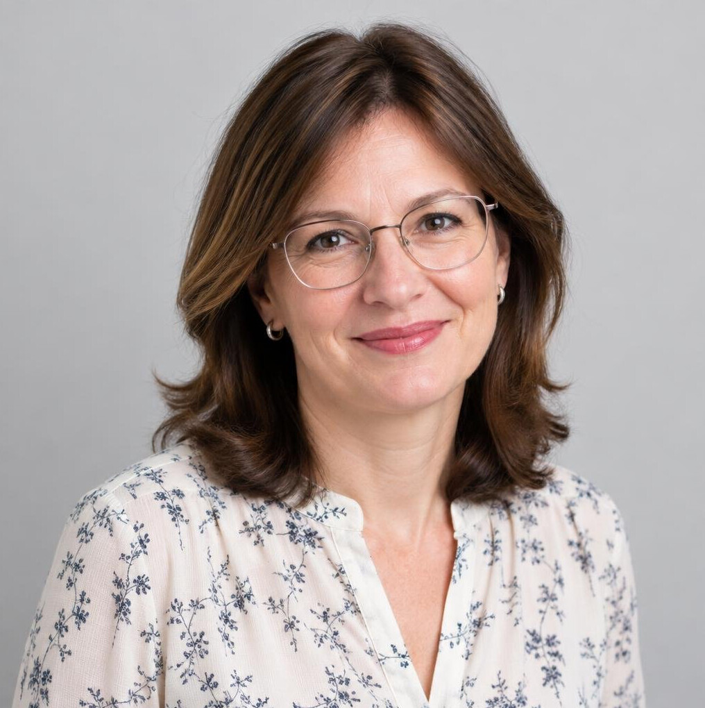 Studio portrait of a Croatian woman editor in her forties wearing glasses